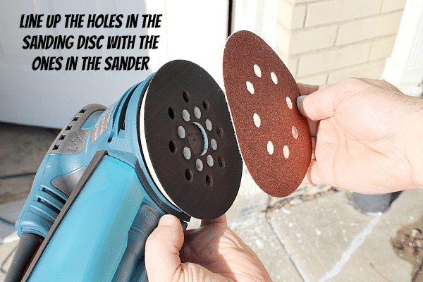 Line up holes in sanding disc