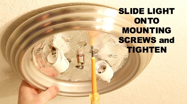 Slide light onto mounting screws