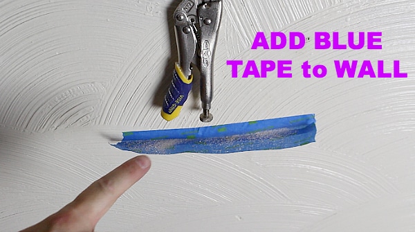 Add blue tape to wall